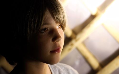 Close-up of cute boy looking away