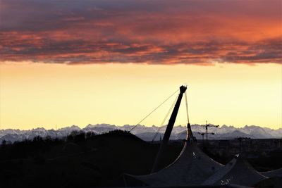 Silhouette of mountain against cloudy sky during sunset