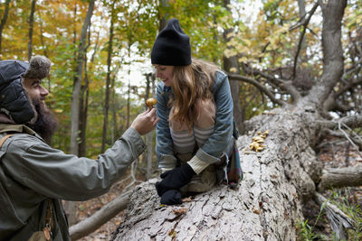 Young couple hanging out in the forest