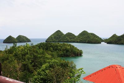 Mountains amidst sea against sky