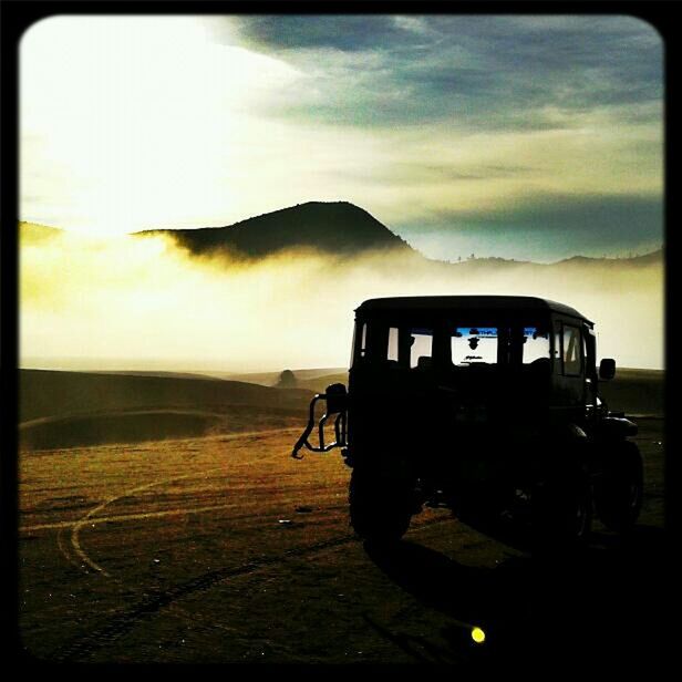 sky, transfer print, sunset, transportation, land vehicle, mode of transport, auto post production filter, cloud - sky, landscape, dusk, mountain, field, cloud, car, outdoors, cloudy, no people, nature, travel, scenics