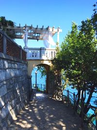 View of building with columns in front of building against blue sky