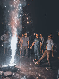 People watching firework display at night