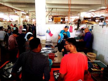 Rear view of people at market stall