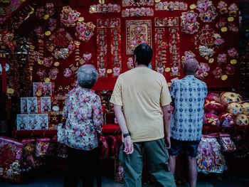 Rear view of people standing outside temple