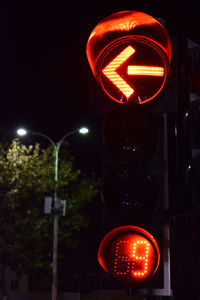 Illuminated road sign at night