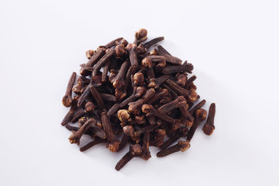 Close-up of cloves over white background