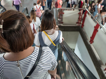 Rear view of women standing in corridor