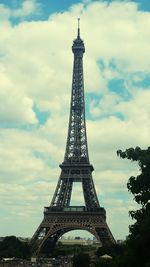 Low angle view of eiffel tower against cloudy sky