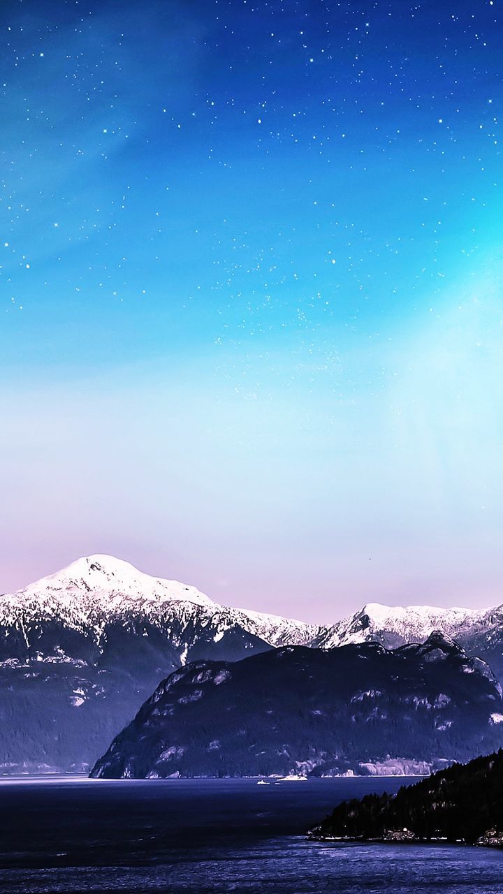 SCENIC VIEW OF SNOWCAPPED MOUNTAIN AGAINST SKY AT NIGHT