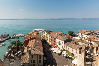 High angle view of buildings by sea against sky