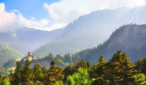 Panoramic view of trees and mountains against sky