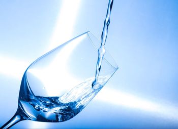 Close-up of wine glass against blue background