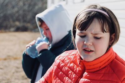 Close-up of siblings standing outdoor