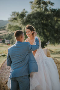 Rear view of couple kissing outdoors