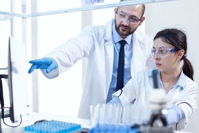 Portrait of female doctor giving medicine in laboratory