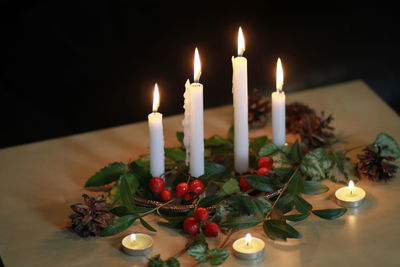 Close-up of illuminated candles on table