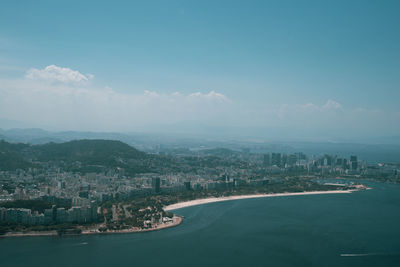 Aerial view of sea and buildings against sky