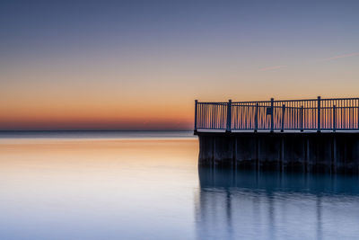 Scenic view of sea against clear sky during sunset