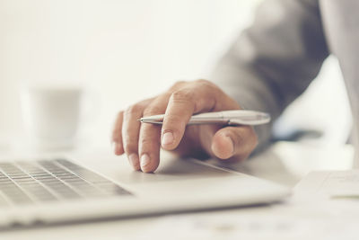 Midsection of man using mobile phone