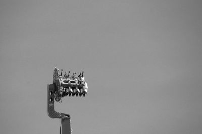 Low angle view of carousel against clear sky