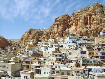 View of buildings and mountain against sky