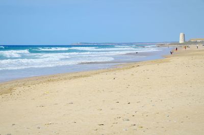 Scenic view of beach against clear sky