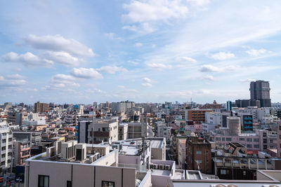 High angle view of buildings in city against sky