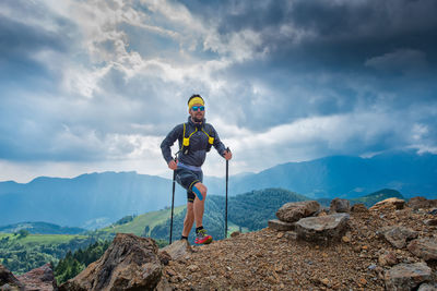 Man standing on mountain against sky