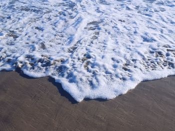 High angle view of waves on beach