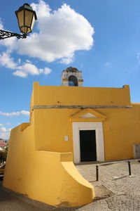 Low angle view of bell tower against sky