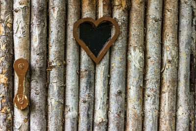 Close-up of heart shape on brick wall