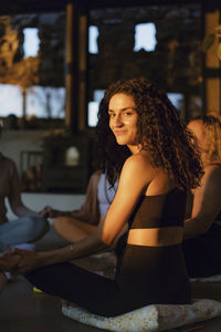 Smiling woman in retreat center at sunset