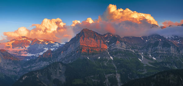 Panoramic view of snowcapped mountains against sky during sunset
