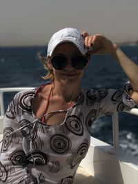 Portrait of woman sitting on boat in sea
