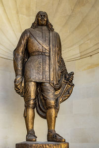 Statue of buddha against wall