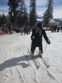 Full length of man on snow covered trees