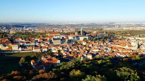 High angle view of houses in town against clear sky