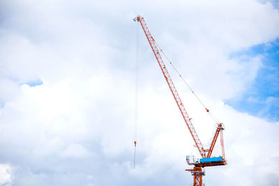 Low angle view of crane against sky