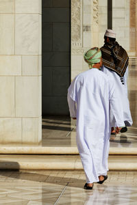 Rear view of man standing against wall