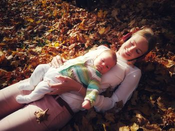 Cute girl lying down on street during autumn