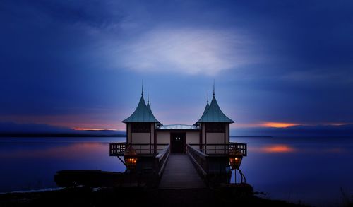 Built structures against sky at sunset