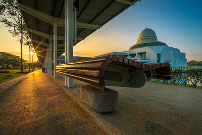 View of illuminated building against sky during sunset