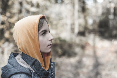 Close-up of girl looking away in forest