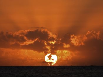 Scenic view of sea against orange sky