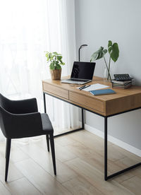 Office workplace with laptop on wooden table