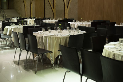 Empty chairs and tables in restaurant