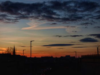 Silhouette of city against dramatic sky