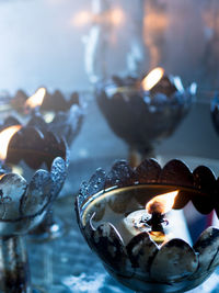 Close-up of lit candles on table