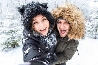 Portrait of a smiling young woman in snow